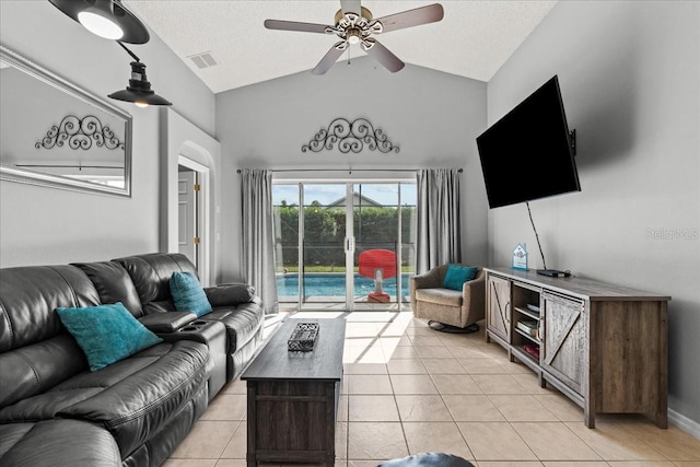 living room with ceiling fan, a textured ceiling, and light tile patterned floors