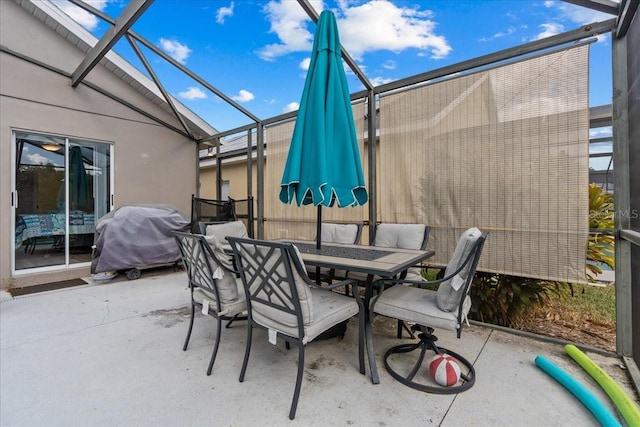 view of patio featuring a lanai and area for grilling