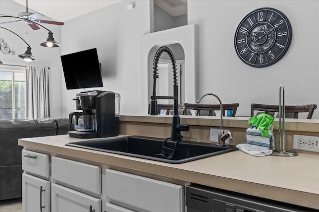 kitchen with dishwasher, white cabinetry, sink, and ceiling fan