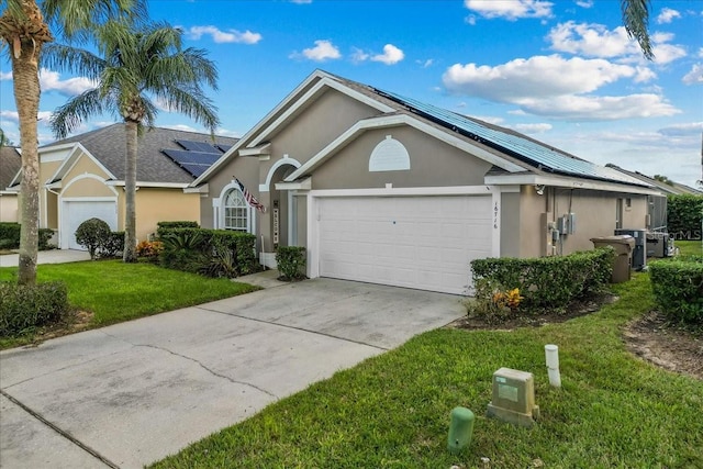 single story home featuring a front lawn and a garage