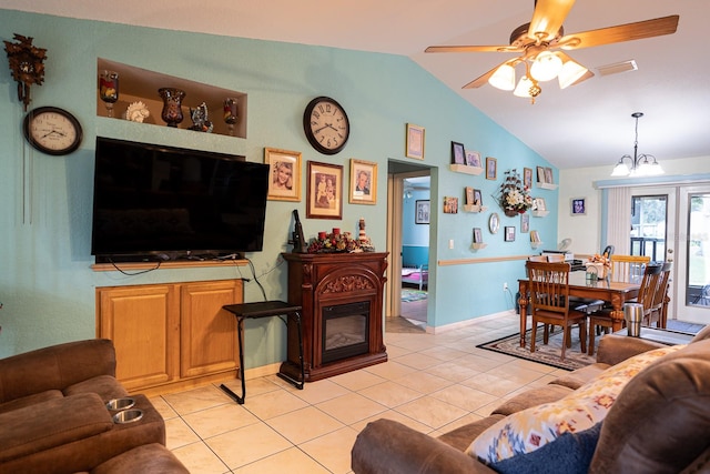 living room with vaulted ceiling, light tile patterned flooring, and ceiling fan with notable chandelier