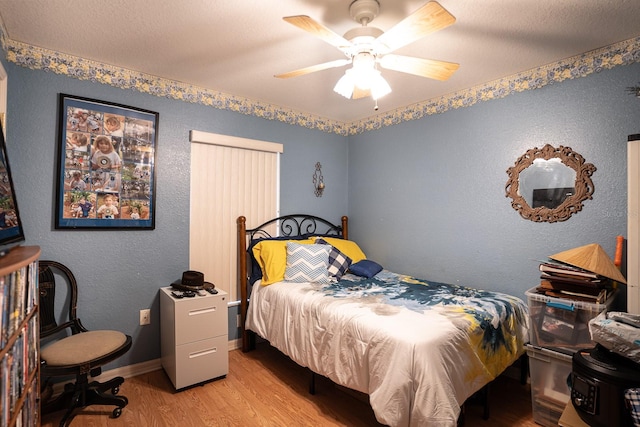 bedroom with ceiling fan and light hardwood / wood-style flooring