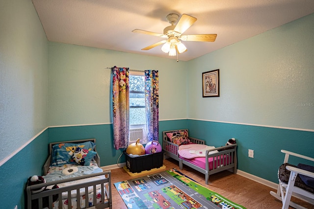 bedroom with hardwood / wood-style floors and ceiling fan