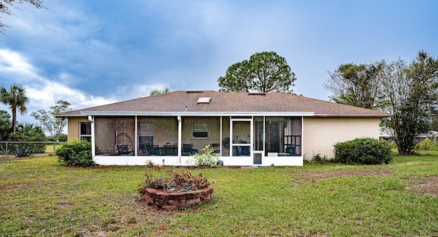 back of house with a lawn and a sunroom