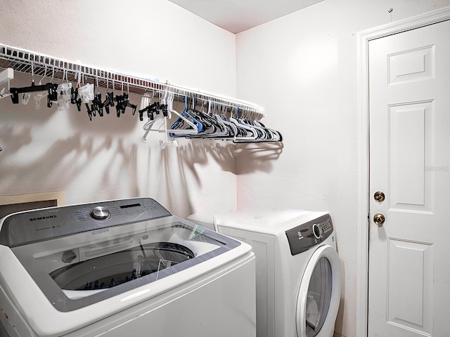 washroom featuring washer and clothes dryer