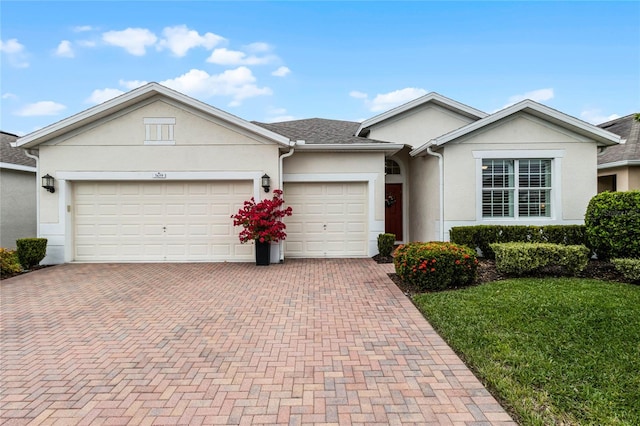 single story home with a garage and a front yard