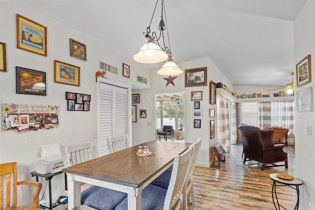 dining area with light hardwood / wood-style floors, lofted ceiling, and ceiling fan