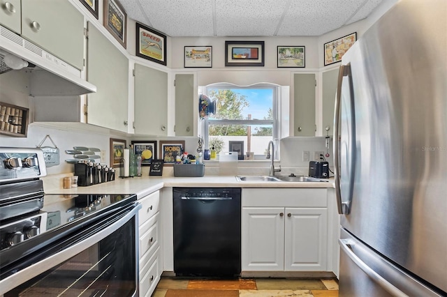 kitchen featuring a drop ceiling, appliances with stainless steel finishes, white cabinetry, and sink