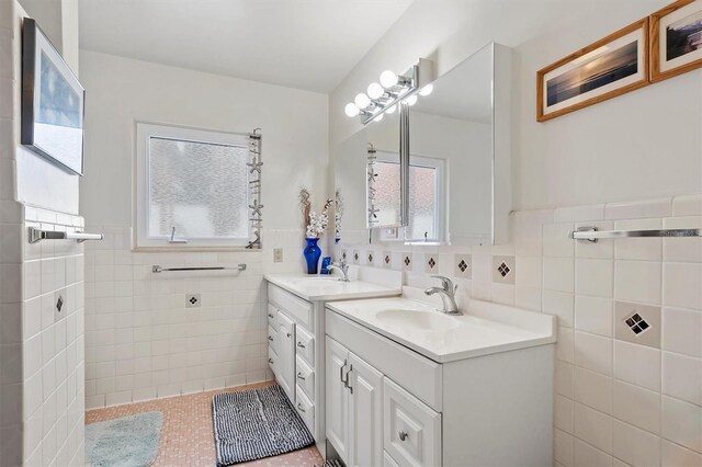 bathroom featuring vanity and tile walls