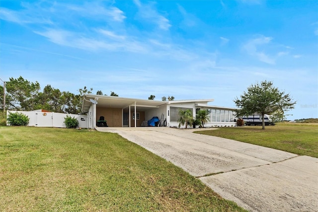 view of front of house with a front lawn and a carport