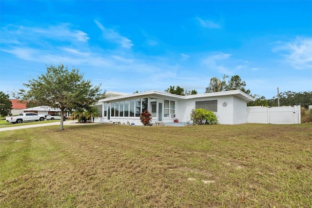 single story home with a front lawn and a sunroom