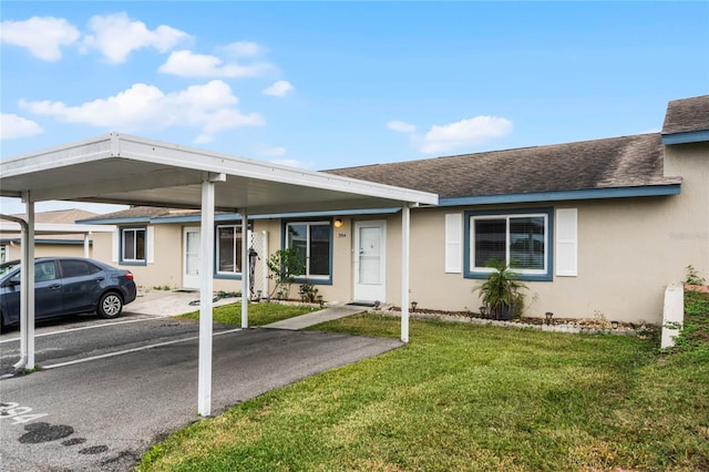 ranch-style home with a front lawn and a carport