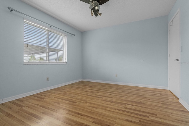 unfurnished room featuring a textured ceiling, ceiling fan, and light hardwood / wood-style flooring