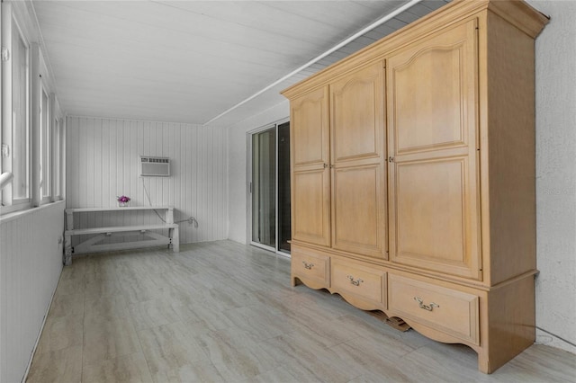 mudroom with wood walls and a wall unit AC