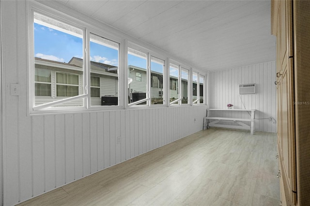 unfurnished sunroom featuring a wall mounted air conditioner