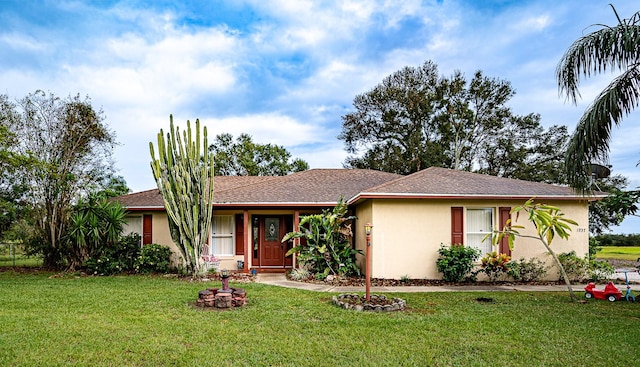 single story home featuring a front lawn