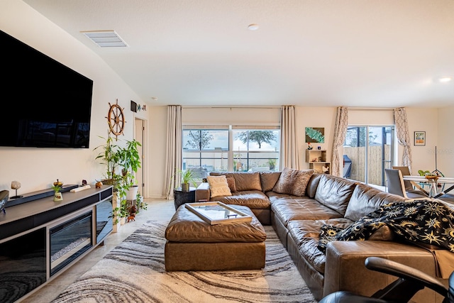 living room with plenty of natural light and lofted ceiling