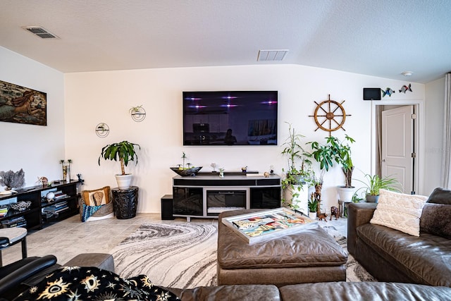 tiled living room with a textured ceiling and lofted ceiling