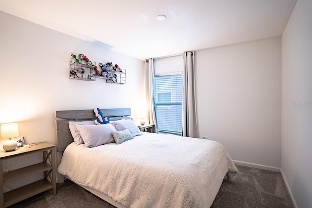 bedroom featuring dark carpet