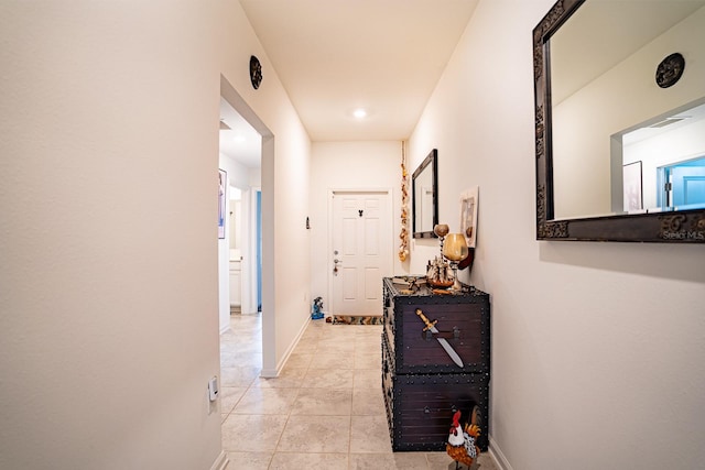 corridor with light tile patterned flooring