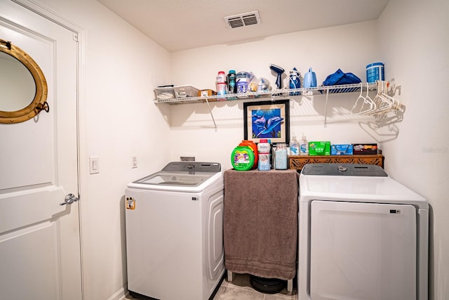 laundry room with independent washer and dryer