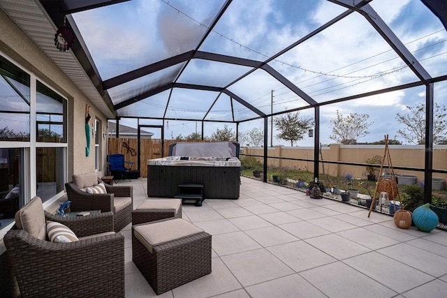 view of patio / terrace featuring a hot tub and glass enclosure