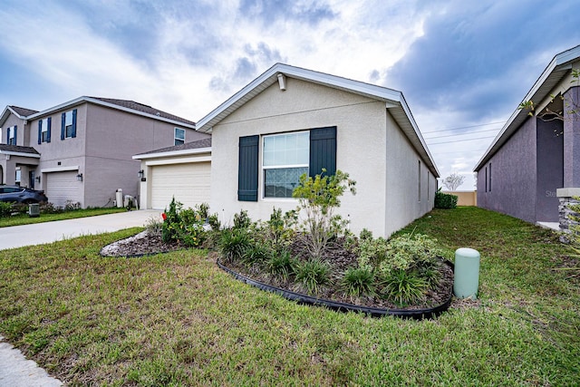 view of front facade with a garage and a front lawn