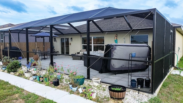 rear view of house with a lanai and a patio area