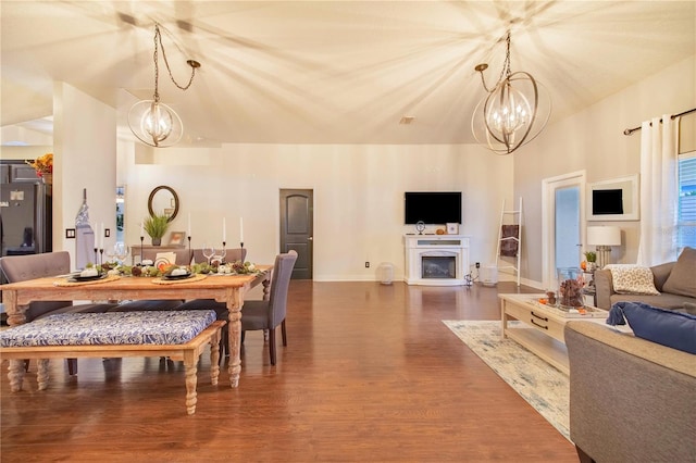 dining space featuring an inviting chandelier and hardwood / wood-style flooring