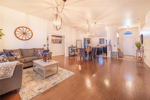 living room featuring hardwood / wood-style floors and a notable chandelier