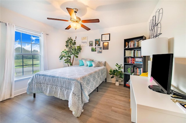 bedroom with light hardwood / wood-style floors and ceiling fan