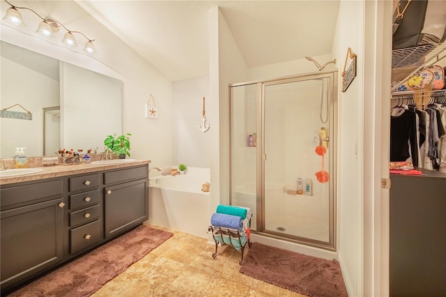 bathroom with vanity and separate shower and tub