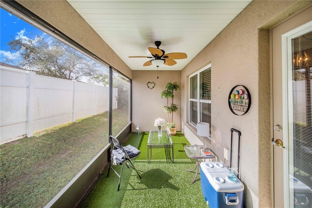 sunroom / solarium featuring ceiling fan