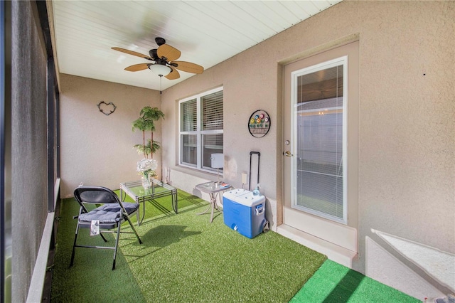 unfurnished sunroom with ceiling fan