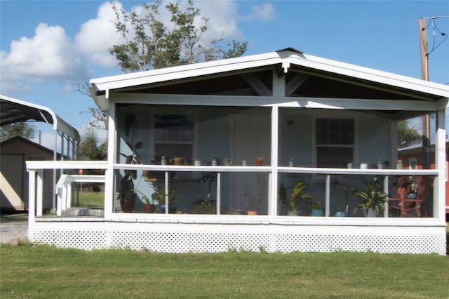 back of property featuring a sunroom