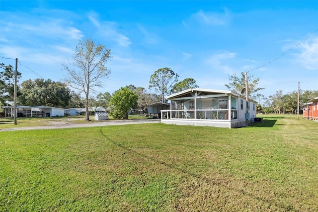 view of yard with a carport and a sunroom