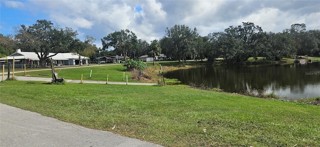 view of home's community featuring a yard and a water view