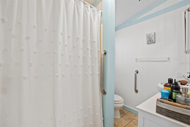 bathroom featuring tile patterned flooring, toilet, and vaulted ceiling