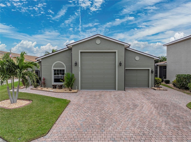 ranch-style house featuring a garage and a front lawn