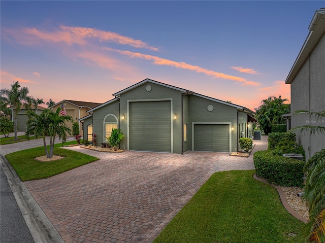 view of front of house featuring a yard and a garage