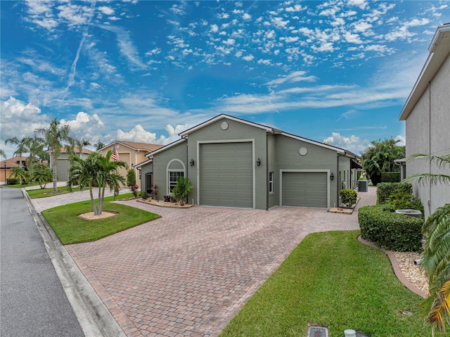 view of front of home with a garage and a front lawn