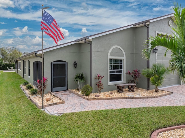 ranch-style home featuring a garage and a front yard