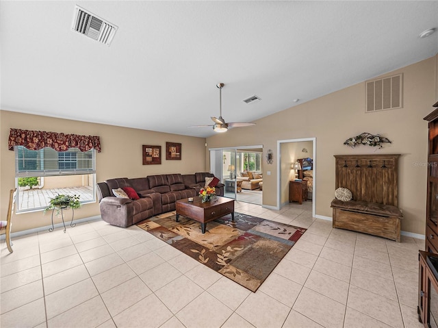 living room featuring lofted ceiling, light tile patterned floors, and ceiling fan