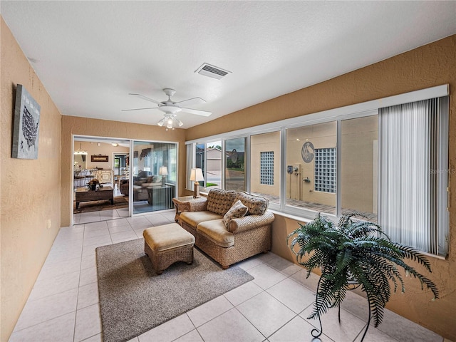 sunroom with ceiling fan