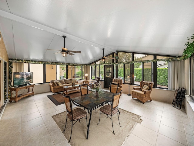 sunroom with a healthy amount of sunlight, vaulted ceiling with beams, and ceiling fan