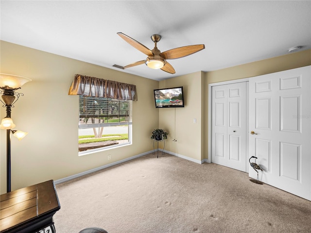 unfurnished room featuring ceiling fan and carpet flooring