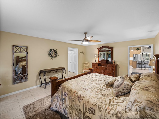 tiled bedroom featuring a closet, ceiling fan, and stainless steel fridge with ice dispenser