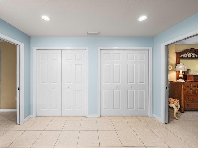 tiled bedroom with two closets