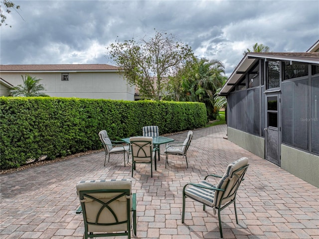 view of patio / terrace featuring a sunroom