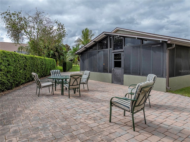 view of patio / terrace featuring a sunroom